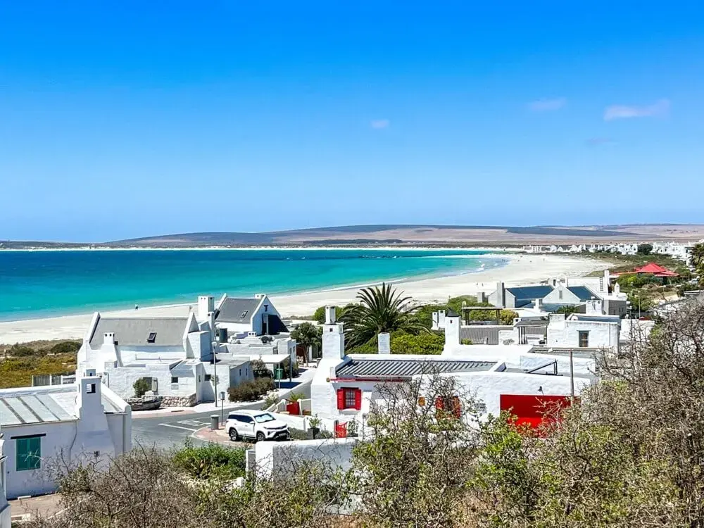White-washed fishermen’s cottages of Paternoster above a long white beach and turquoise bay